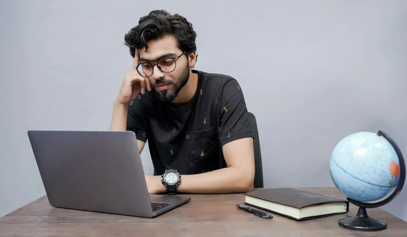 Student working through a lesson on his laptop