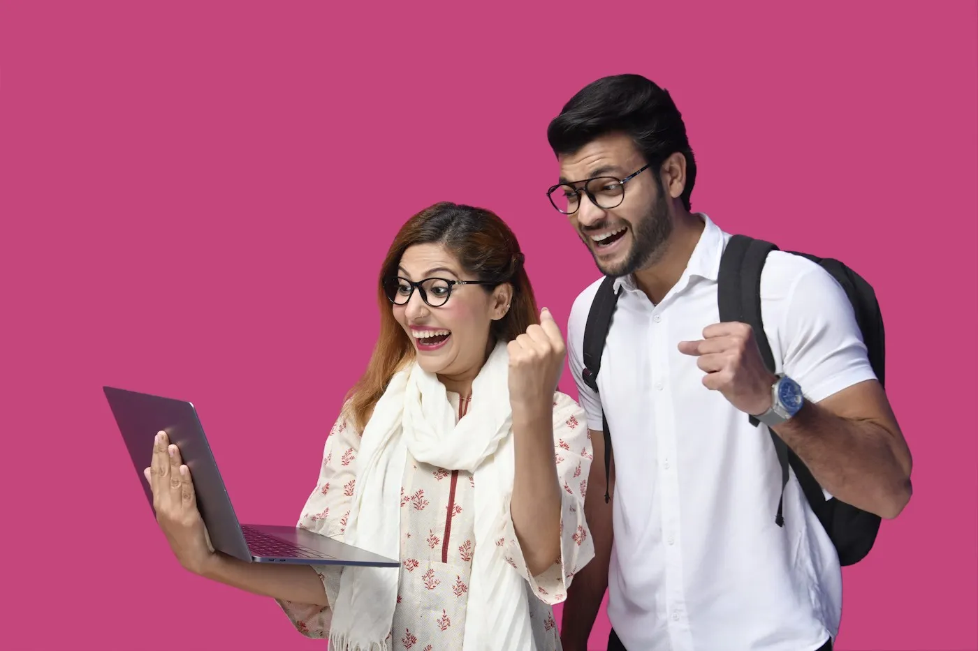 Two students celebrating a result on a laptop