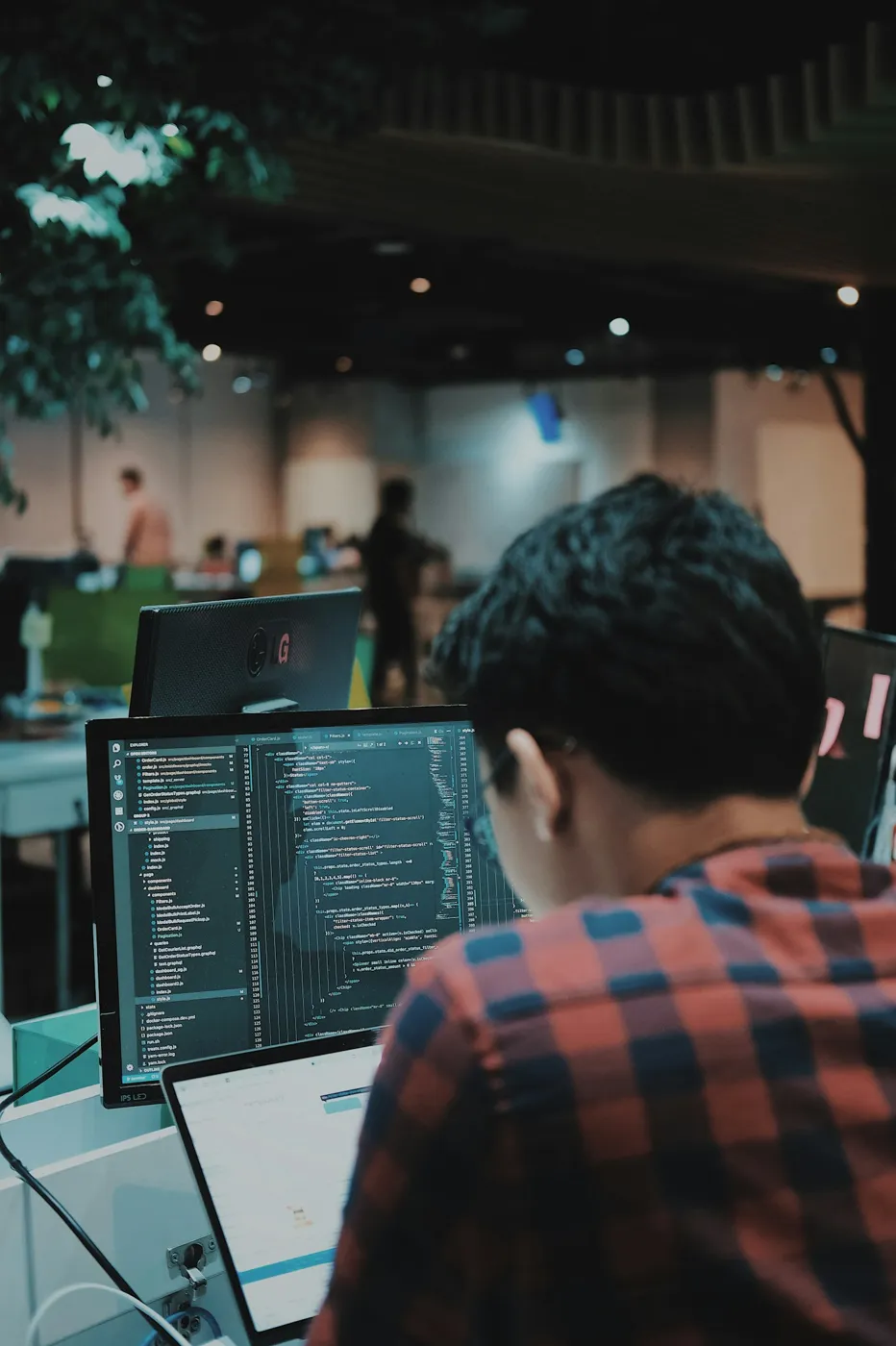 Student writing code on a desktop computer